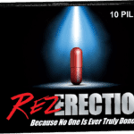 A red pill sitting on top of a black box.